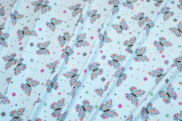 Vendita on line tessuto maglina cotone fantasia farfalle fondo azzurro - tessuti abbigliamento magline / jersey/tessuto in
